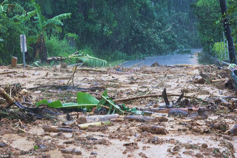 A road blocked is blocked by a mudslide caused by Hurricane Fiona in Cayey, Puerto Rico on Sunday