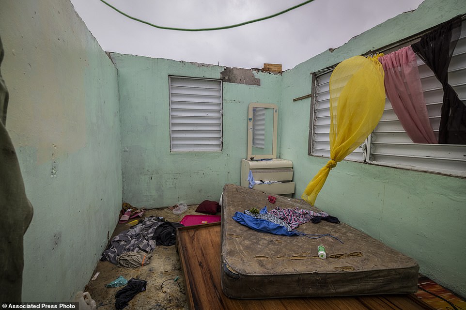 Nelson Cirino's home stands with its roof torn off by the winds of Hurricane Fiona in Loiza, Puerto Rico