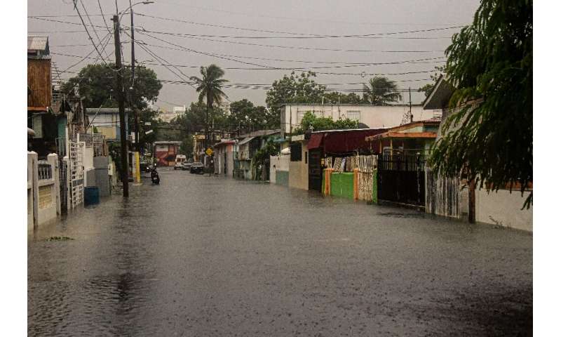 A flooded road is seen during the passage of Hurricane Fiona in Villa Blanca, Puerto Rico