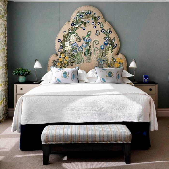 A bed with a large floral headboard in the Ham Yard Hotel