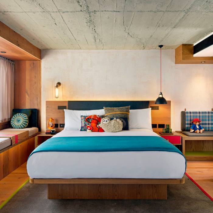 A room in London’s Treehouse Hotel, with a midcentury-style bed and furnishings