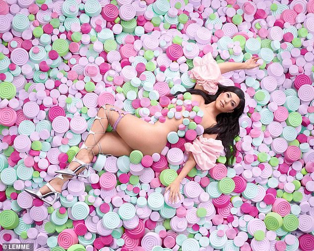 Her body is a big part of this ad campaign: Kourtney was nude while in a sea of fake pills