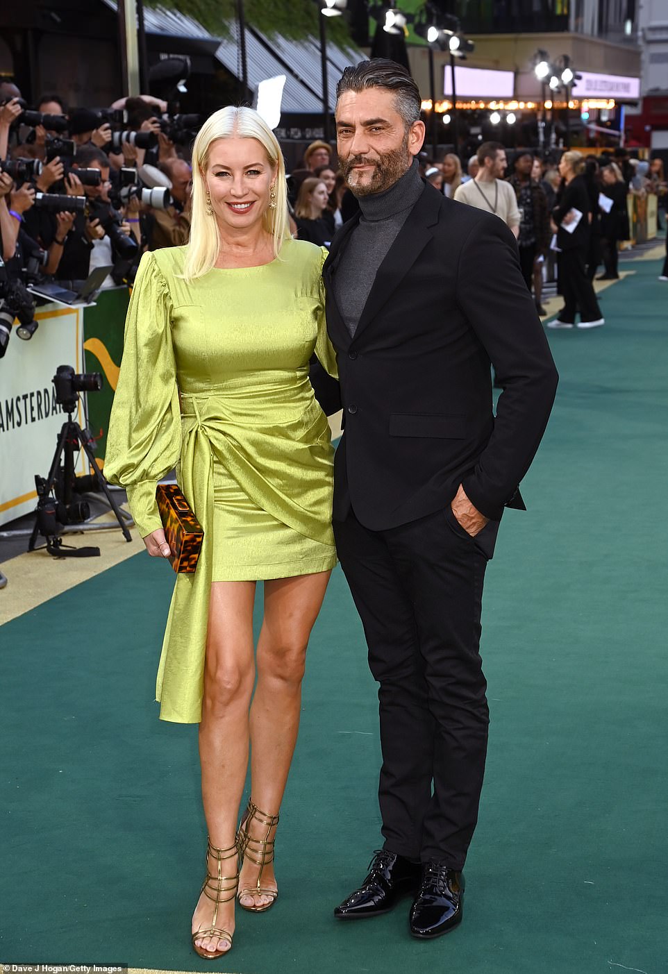 Date night! Showcasing her endless pins, Denise was accompanied by her boyfriend Jimmy Barba for the film event, as she opted for an eye-catching lime dress and a leopard print clutch bag