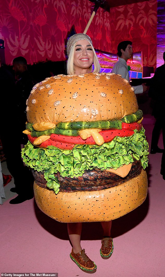 Delicious: Pop singer Katy famous wore one of the brand's looks to the Met gala in 2019 where she dressed as a chandelier before slipping into a burger costume (pictured)