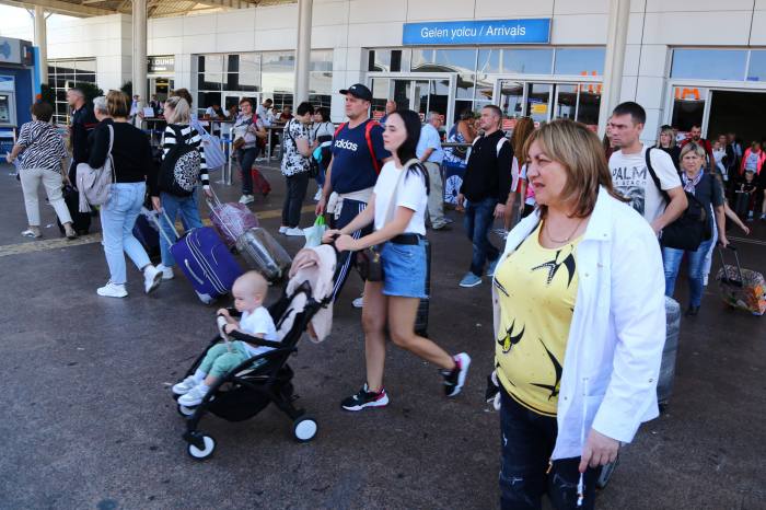 Tourists, coming mainly from Russia, leave from the arrival terminal at Antalya International Airport in the Mediterranean resort city of Antalya, Turkey, on September 22, 2022