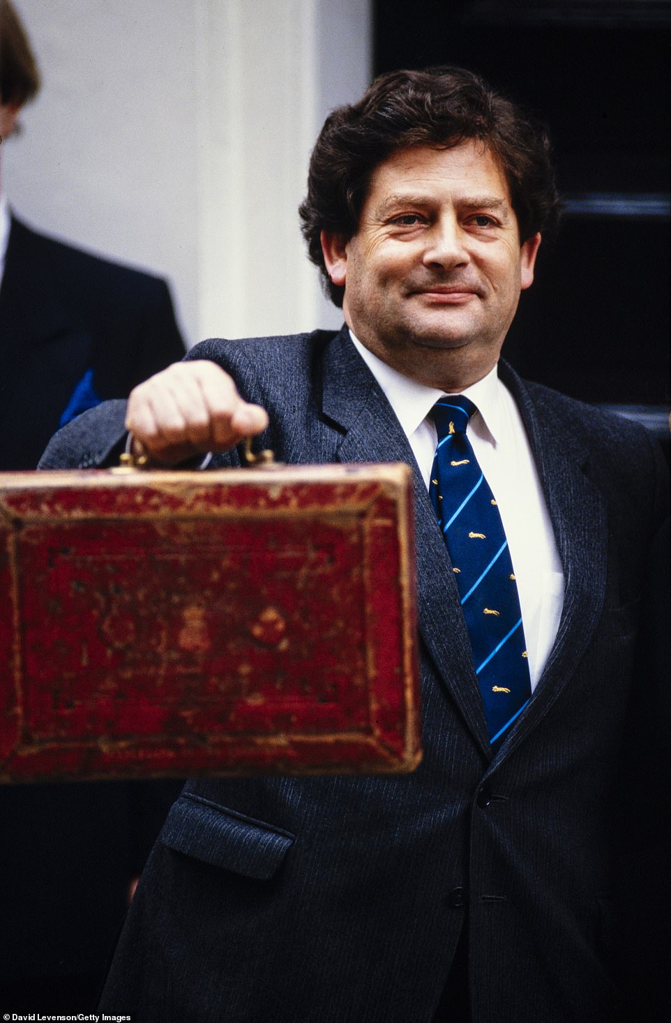 Lauded: Nigel Lawson with his Budget red box. The former Chancellor is pictured outside 11 Downing Street. Then-chancellor Lord Lawson used his budget to slash income tax, cutting the basic rate by 2p in the pound and scrapping all higher rates above 40 per cent in 1988