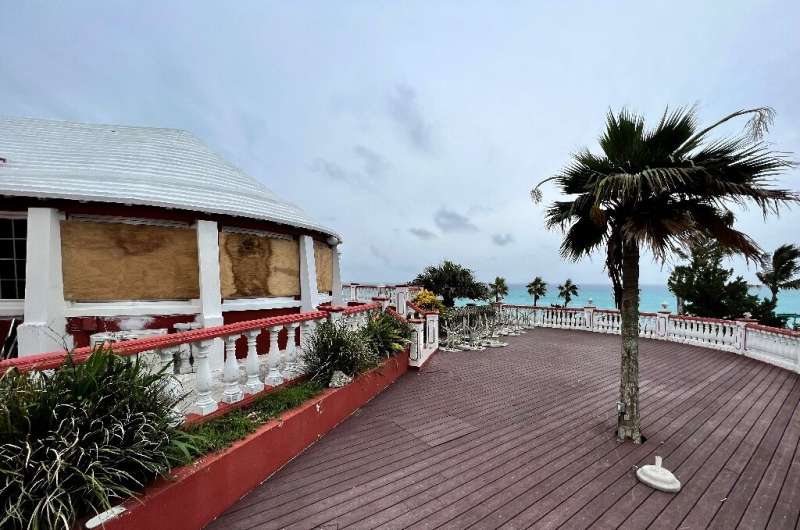 The outdoor furniture has been removed and windows boarded up at Henry VII restaurant on Bermuda's South Shore ahead of Hurrican