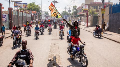 Demonstrators from different cities, holding banners and placards, gather to protest, demanding the removal of Prime Minister Ariel Henry.