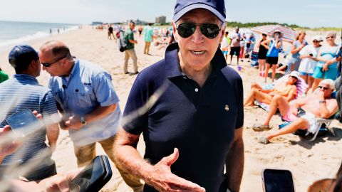 President Joe Biden speaks to reporters as he walks on the beach in Rehoboth Beach, Delaware, on June 20.