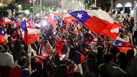 Some waved flags as they celebrated the rejection of the proposed constitution.