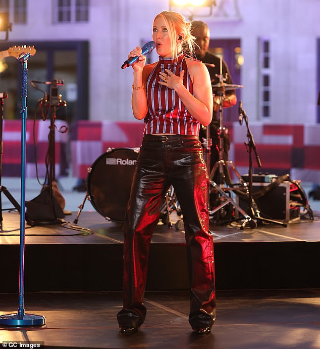 Ellie Goulding flashes a hint of her abs in a striped crop top and leather flares