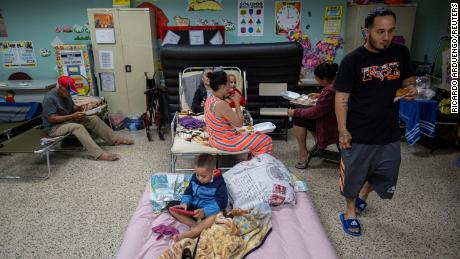 Evacuees are seen in a classroom of a public school being used as a shelter as Hurricane Fiona and its heavy rains approach in Guayanilla, Puerto Rico, on Sunday.