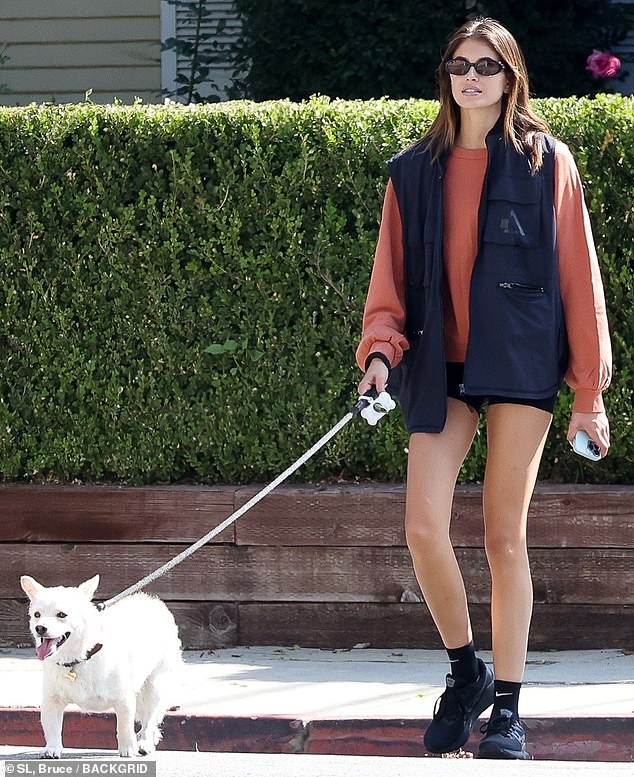 Kaia Gerber shows off toned legs in short shorts as she walks with her adorable pup and friend in LA