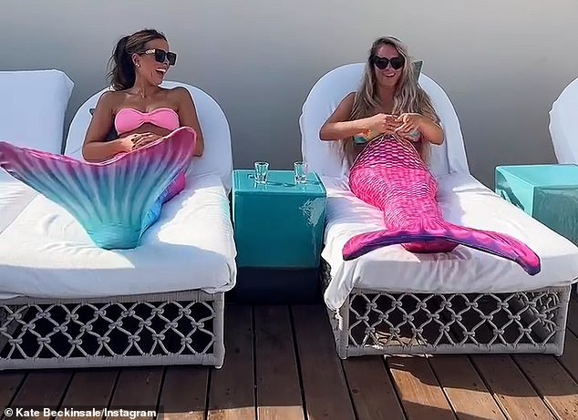 Kate Beckinsale poses in a pink bikini and mermaid’s tail while dancing to Cher with pal 