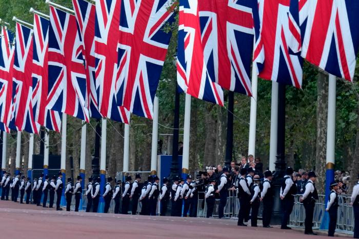 Police and Union Flags line the route along The Mall: thousands of Met police officers are being deployed