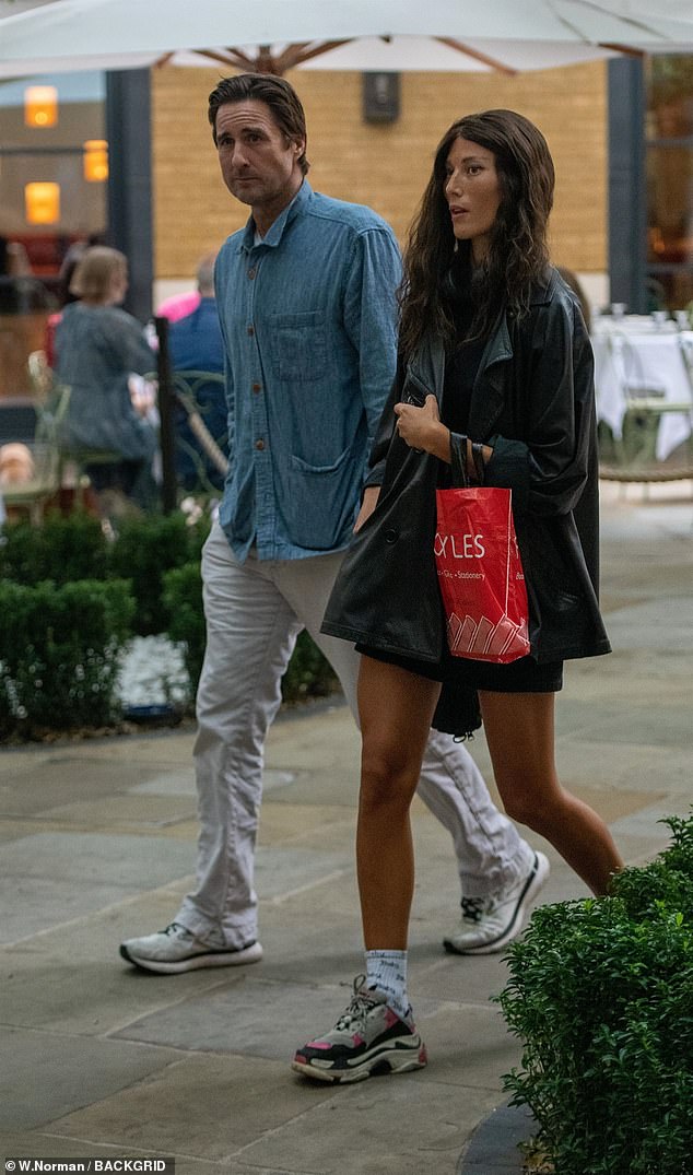 Luke Wilson puts on a cosy display with mystery brunette as they depart London hotel