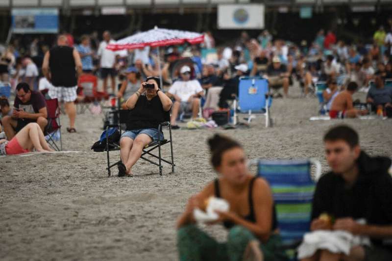 Tourists on a Florida beach await the launch of NASA's new Moon rocket before it was called off on August 29, 2022