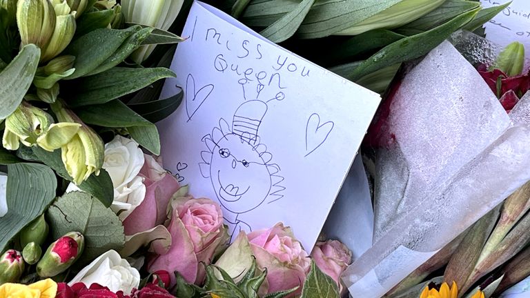 Members of the public look at floral tributes at Balmoral in Scotland following the death of Queen Elizabeth II on Thursday. Picture date: Saturday September 10, 2022.
