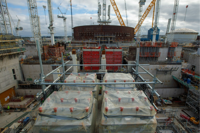 Spring boxes, covered in plastic sheets for protection, on top of columns