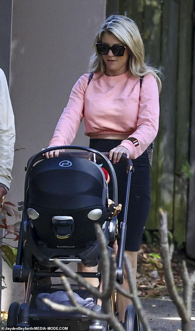 Tegan Kynaston is seen for the first time since giving birth as she enjoys a stroll with her son