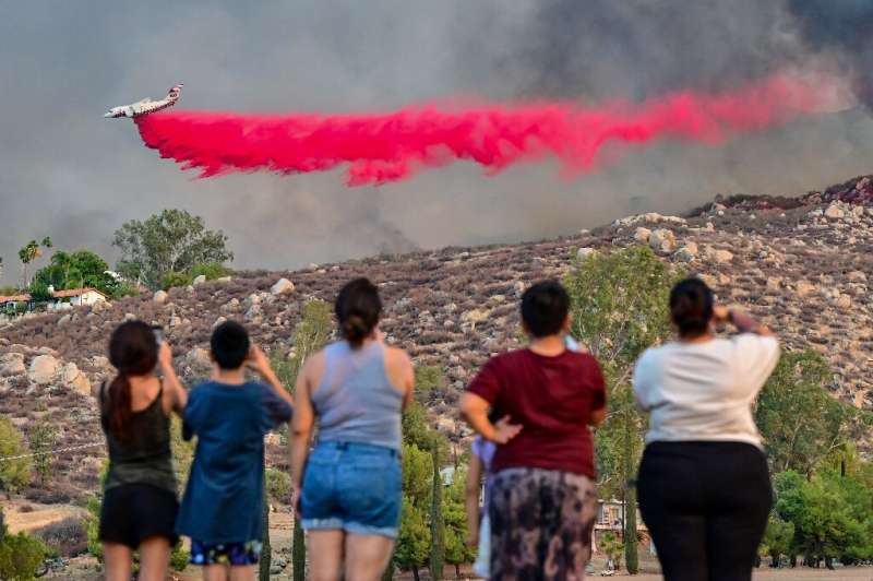 At least two people have died in the Fairview Fire to the southeast of Los Angeles, with firefighters battling ferocious heat as