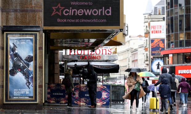 People walk past a Cineworld in Leicester's Square in London