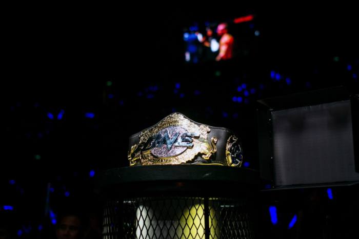 A One Championship belt sits near the cage during an event in Macau