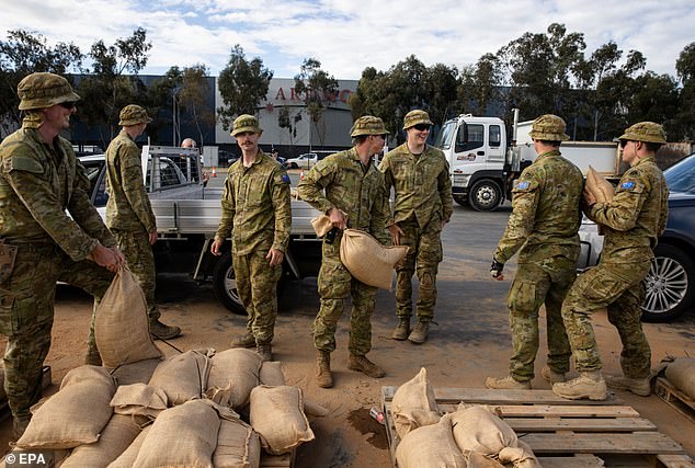 Australian Defence Force personnel (pictured) load residents' cars with sandbags amid floods in Shepparton, Victoria Australia, October 16, 2022