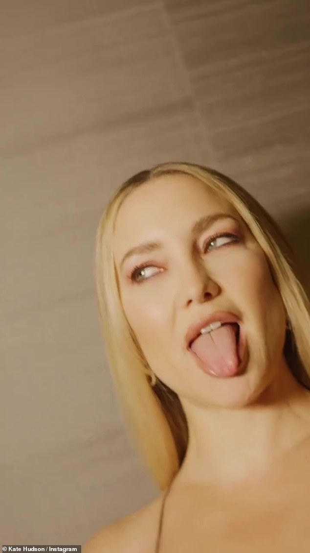 Tongue out: The Almost Famous star puckered up her lips and stuck her tongue out at the camera in the video which flashed to different parts of her fit physique