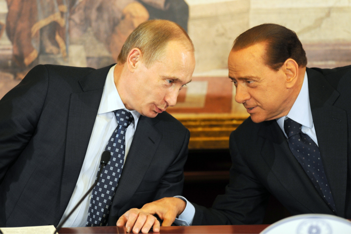 Berlusconi’s and Putin touch hands as they confer during a press conference in 2010