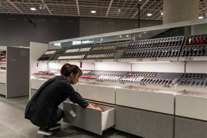 An employee arranges cosmetics inside AmorePacific’s headquarters in Seoul