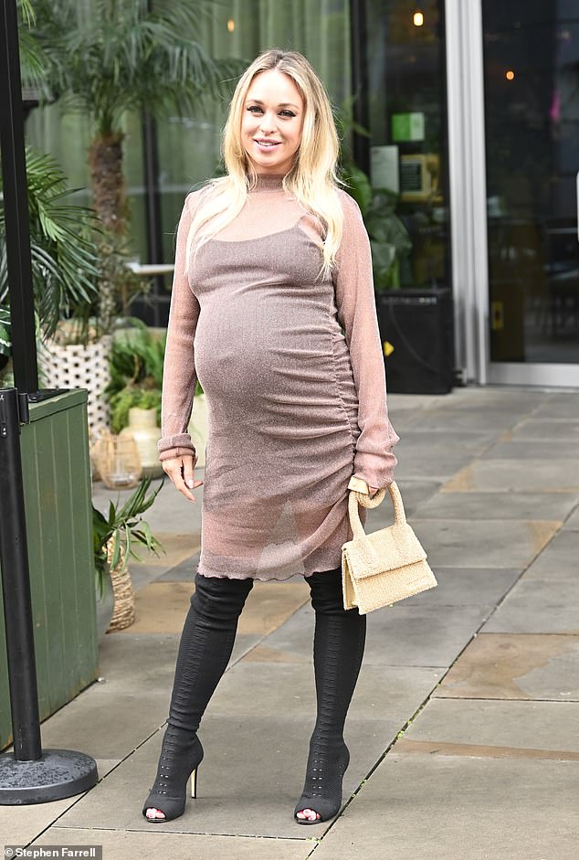 Stunning: The beauty donned a black slip under the long sleeves number keeping her modesty and elevated her frame in a pair of open toe thigh high black boots