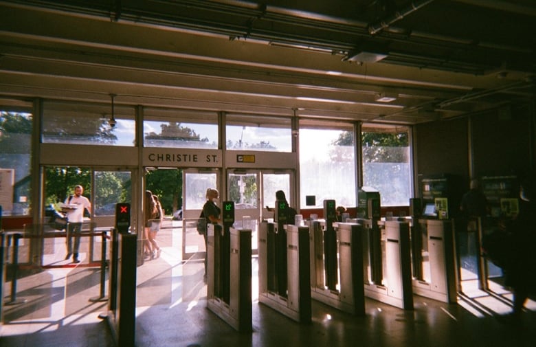 A sunlit entrance of a subway station. 