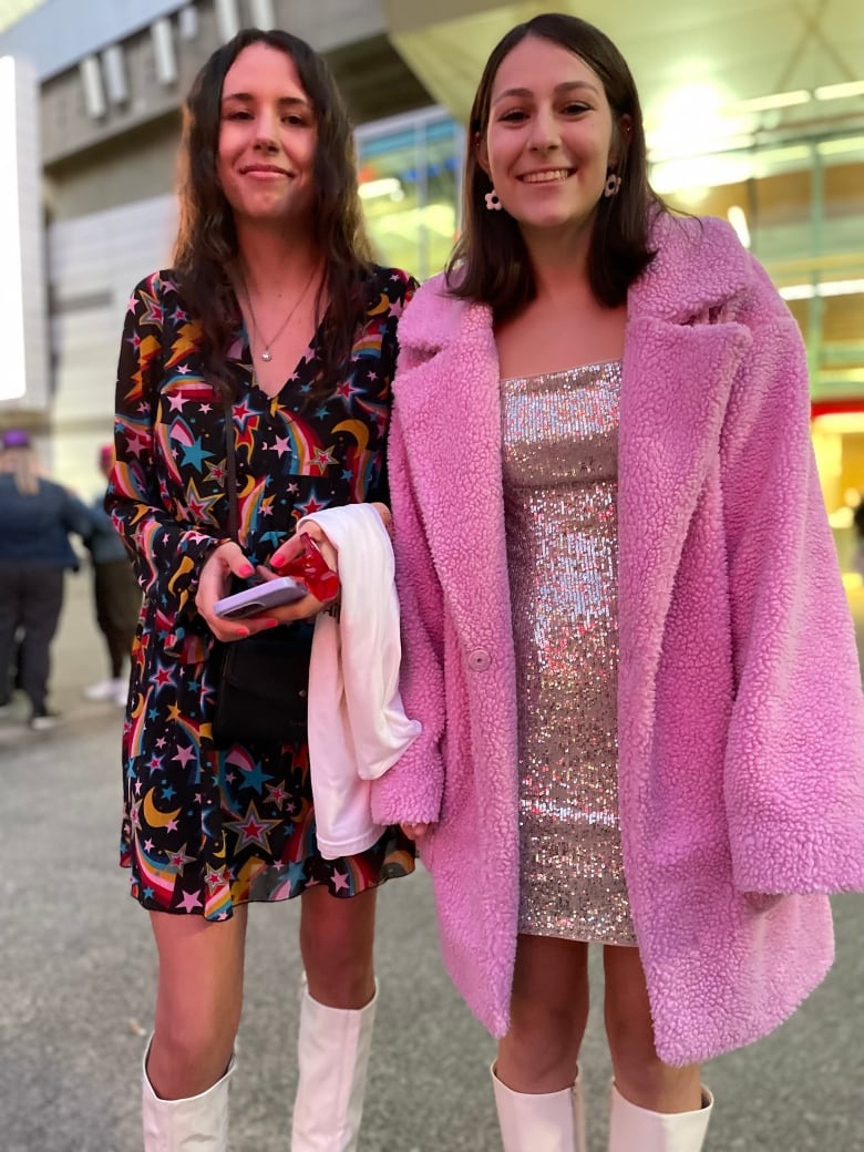 Two young women wearing fancy clothes.