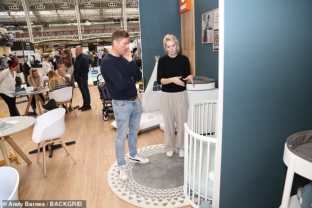 Learning: He spoke to staff who showed him cots and baby-safe furniture at the event on Sunday