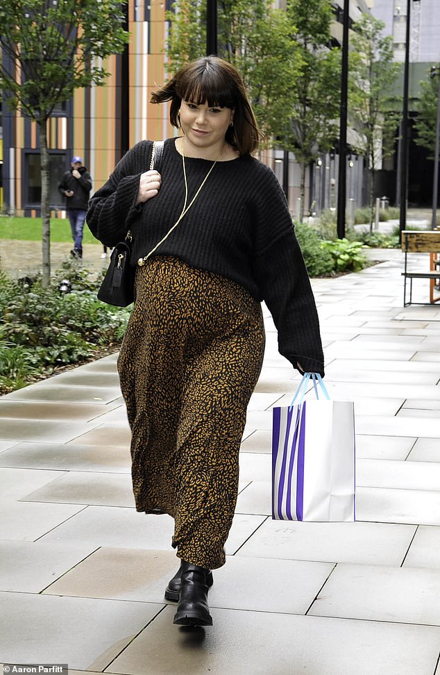 Support: Holding a gift bag as she walked to the central Manchester event, Jessica wore her chocolate brown locks straight and styled her fringe