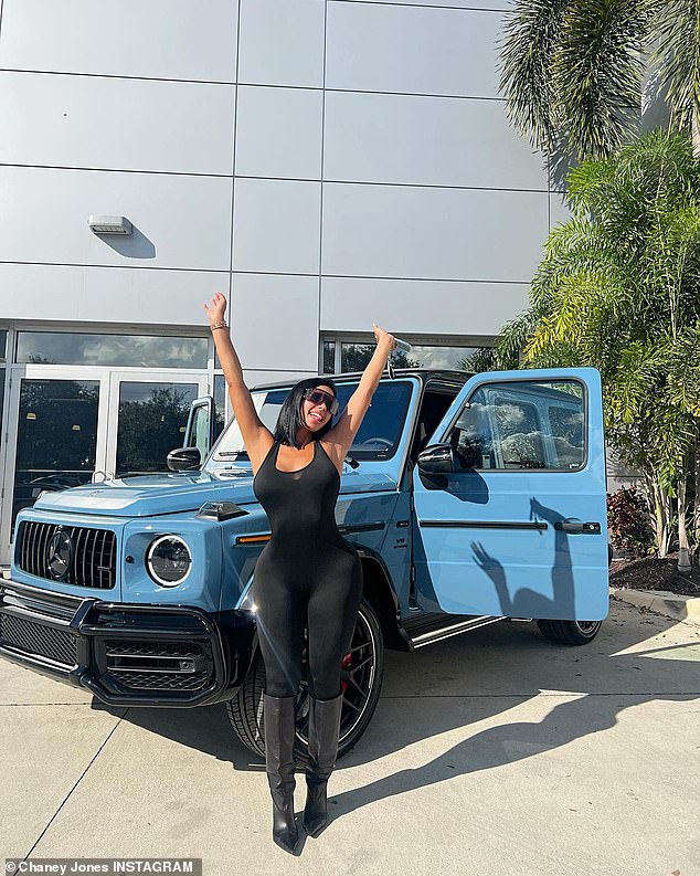 Blue mood: The dark-haired beauty beamed ear-to-ear while posing next to what looked like a new Mercedes