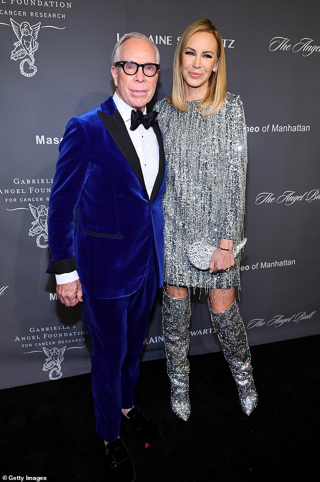 In style: Designer Tommy Hilfiger, 71, was dapper in a vivid blue velvet tuxedo, while his wife Dee Hilfiger, 55, wore an ornate fringe silver dress, sparkly boots and a wing-shaped purse