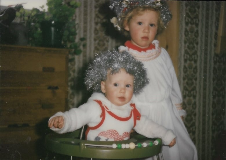 Two girls dressed in traditional Swedish clothes.