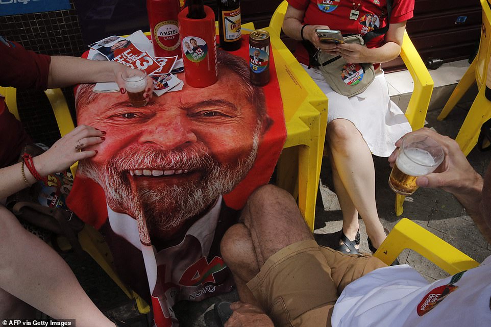 Supporters of Brazil's former President Lula and candidate of the left Workers Party enjoy a beer at a bar in downtown Sao Paulo on election day