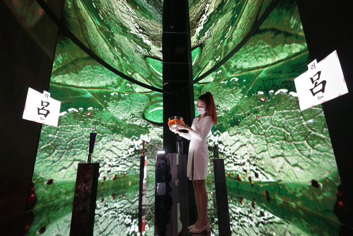 A worker stands at an AmorePacific booth