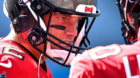 Brady talks to Nick Leverett of the Tampa Bay Buccaneers before the game against the Carolina Panthers.