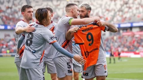 The Roar's Charlie Austin holds up a jersey with Kudo's name and number on the back after scoring on Saturday. 