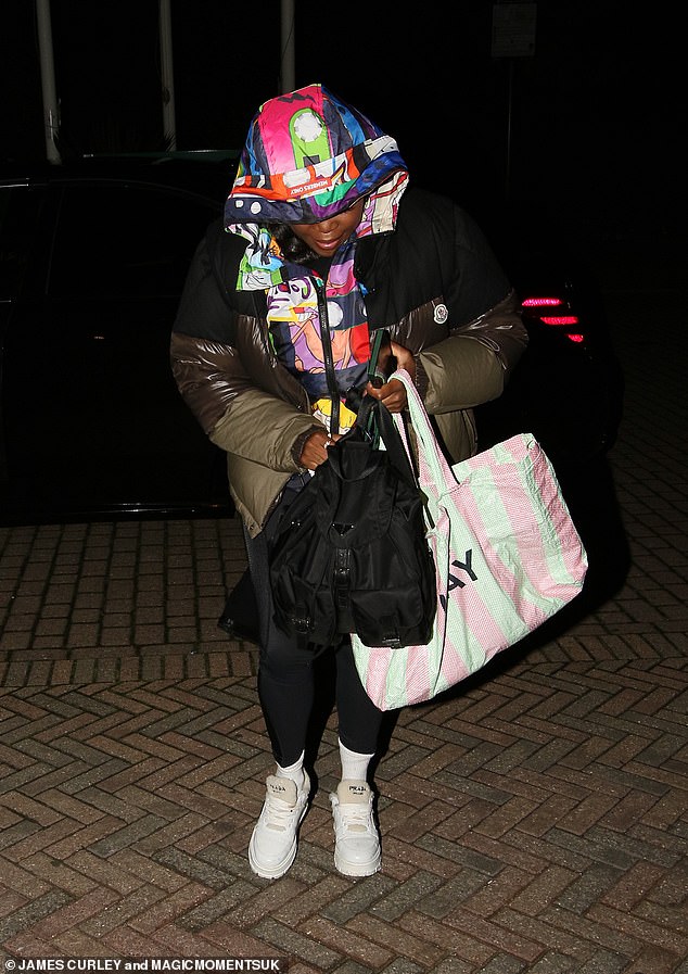 Motsi Mabuse wraps up in a coat with colourful comic prints as she arrives at hotel after Strictly