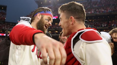 Bryce Harper of the Philadelphia Phillies celebrates with J.T. Realmuto after defeating the San Diego Padres in Game 5 to win the National League Championship Series on October 23, 2022 in Philadelphia.