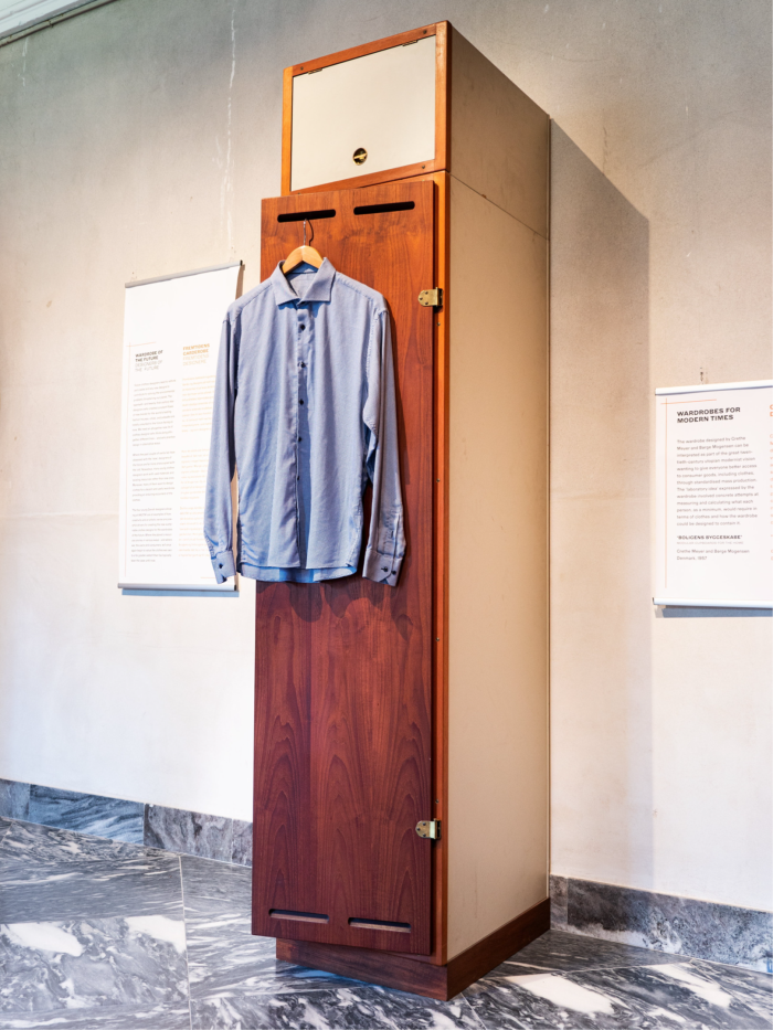 A slender modernist closet from the mid-1950s with a brown wooden door