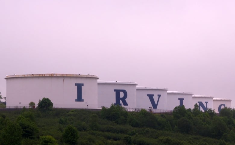 Large oil tanks spell out the letters I-R-V-I-N-G. 