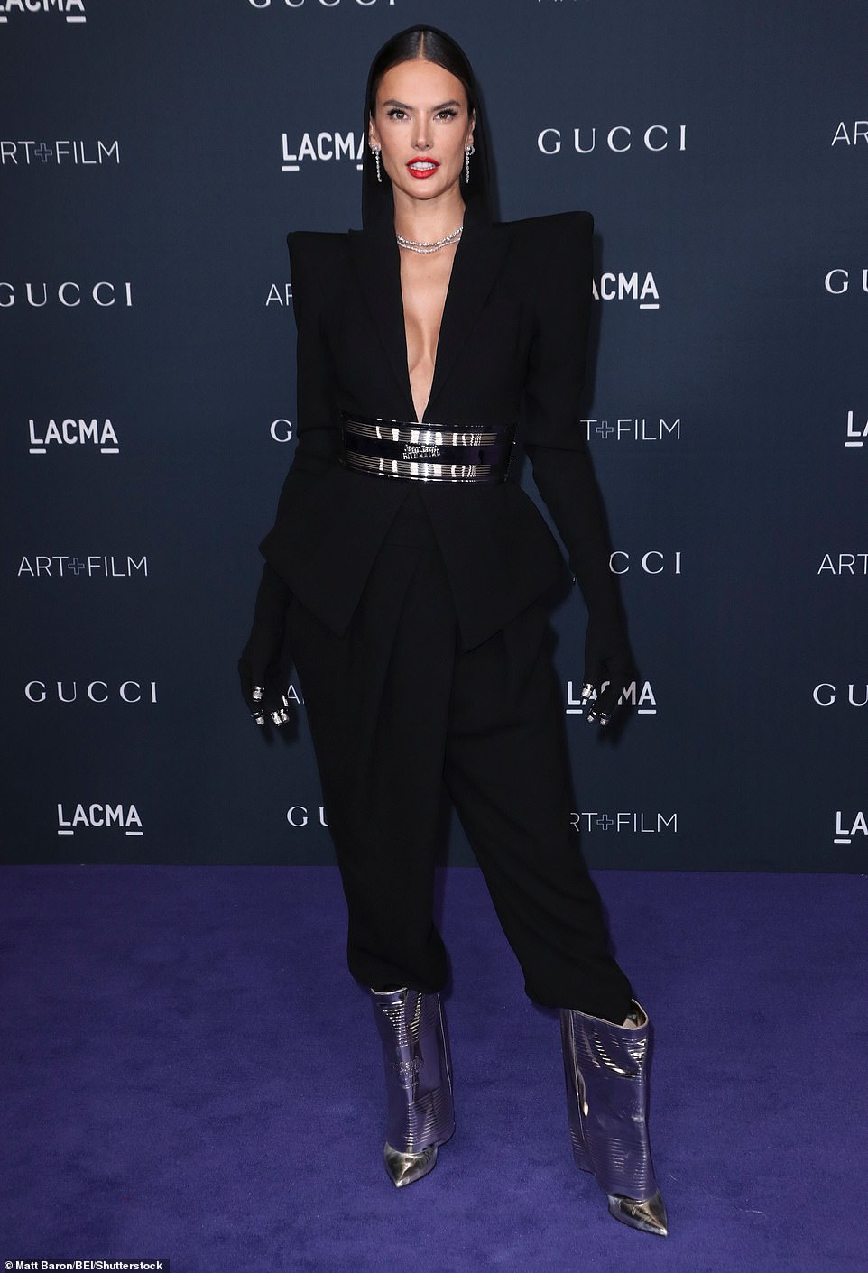 Plunging: The Brazilian beauty's jacket boasted a plunging V-neck with exaggerated pointed shoulder pads, and elbow length sleeves. A wide black and silver belt cinched in her tiny waist and helped create a peplum hem