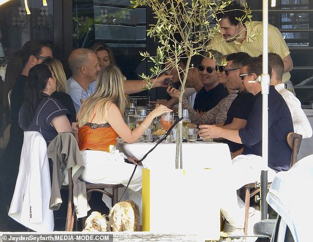 The lively group appeared to be having a good time as they dined at the swanky restaurant