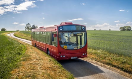 Rural bus service bus on a narrow country road in Suffolk, England, UK.